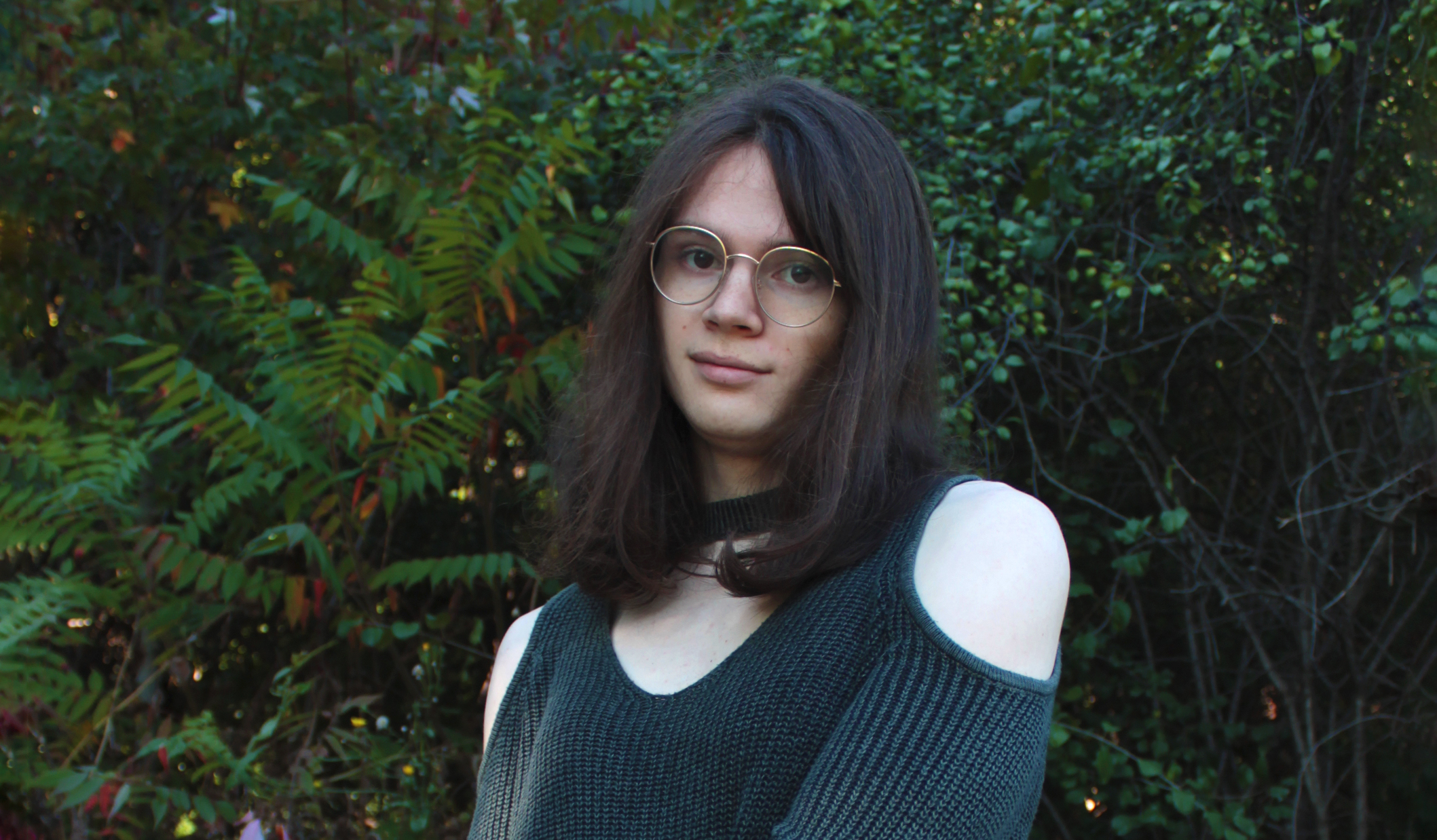 A picture of Valery Marier in front of some leaves.