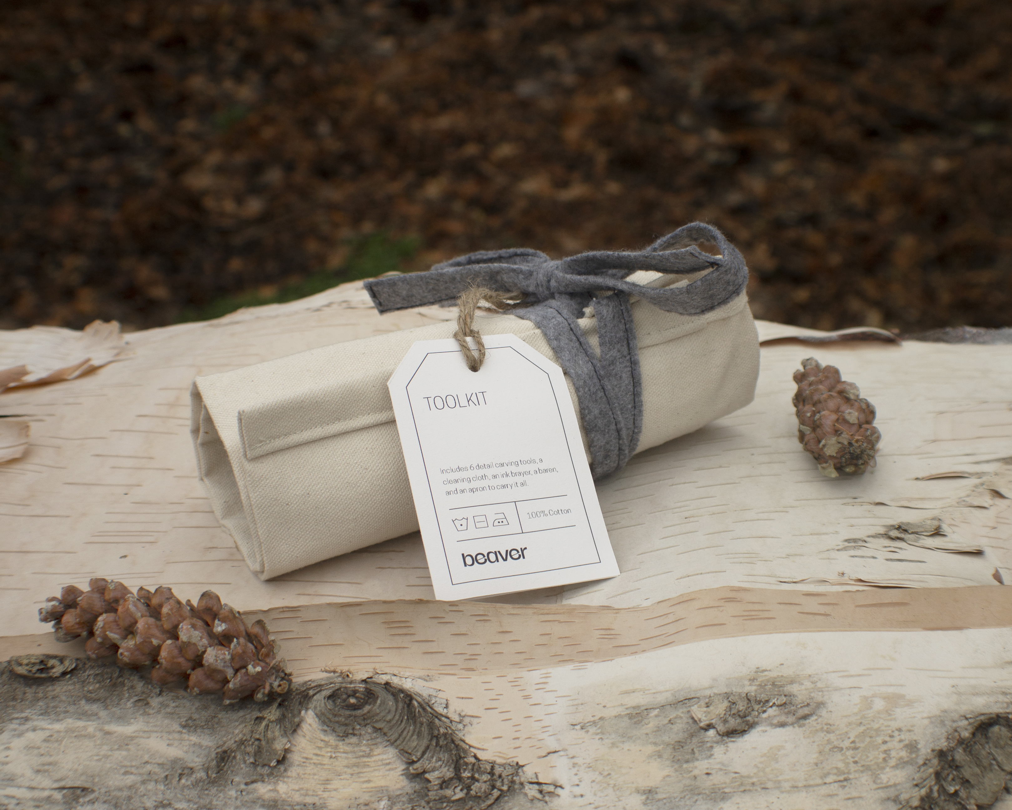 A spotlight photograph of the packaging for the Beaver block printing kit, showing the tool roll that also doubles as a half apron