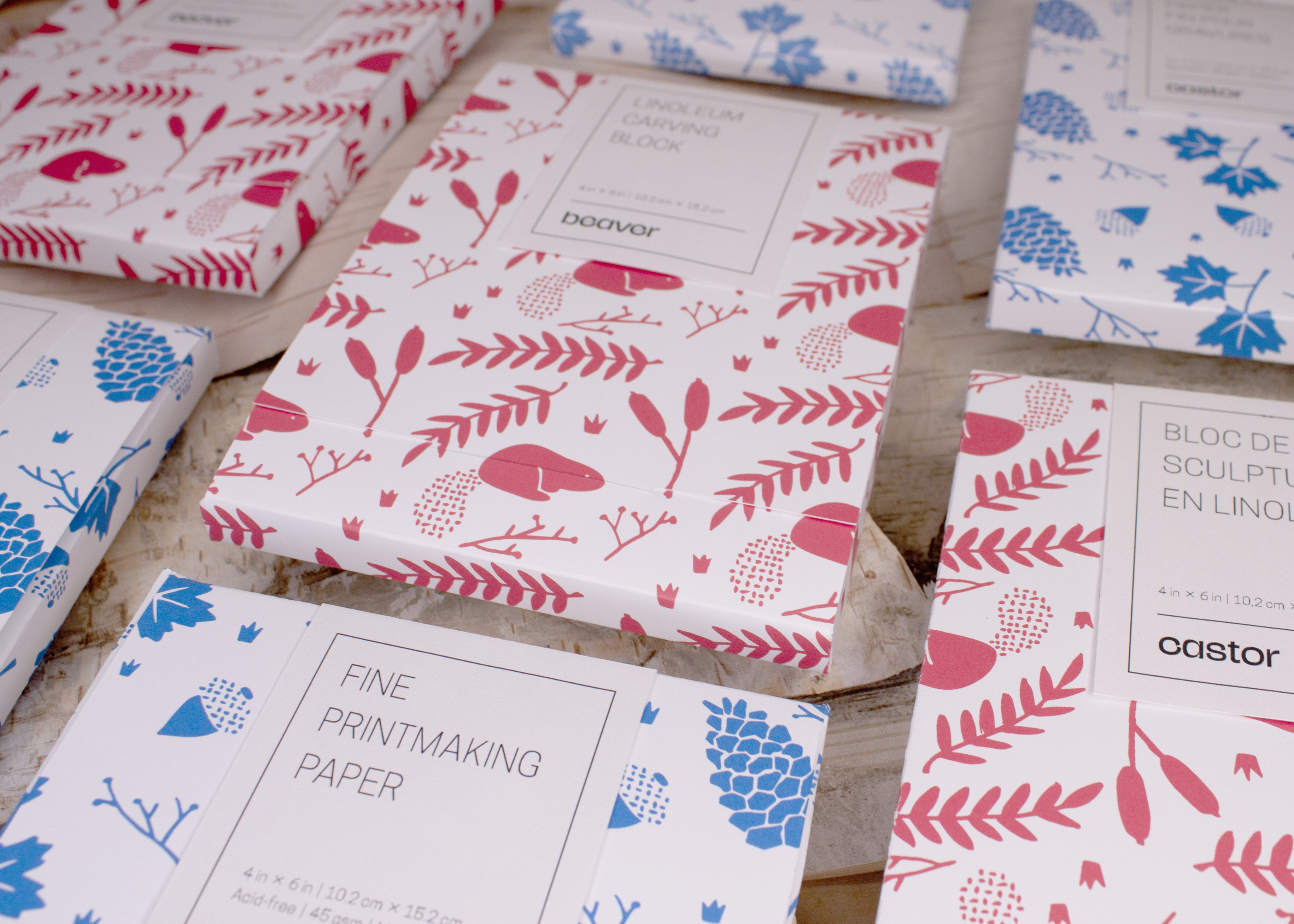 A spotlight photograph of the packaging for the Beaver block printing kit, showing boxes of carving blocks and paper laid out in a grid